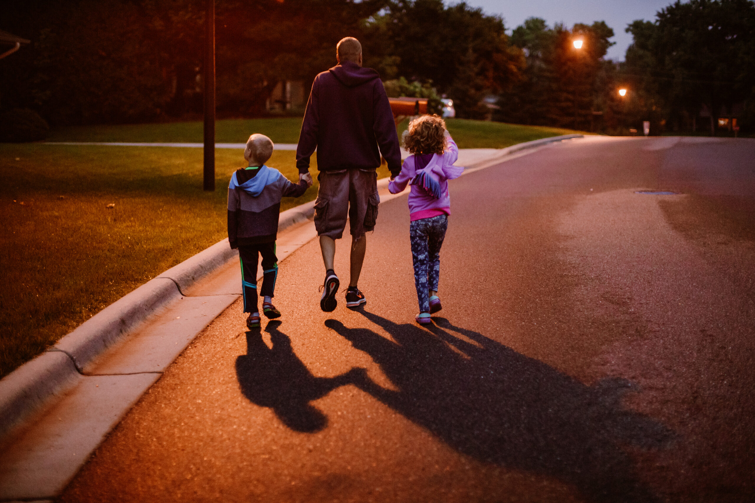 Family walking under Streetleaf solar streetlights in a neighborhood